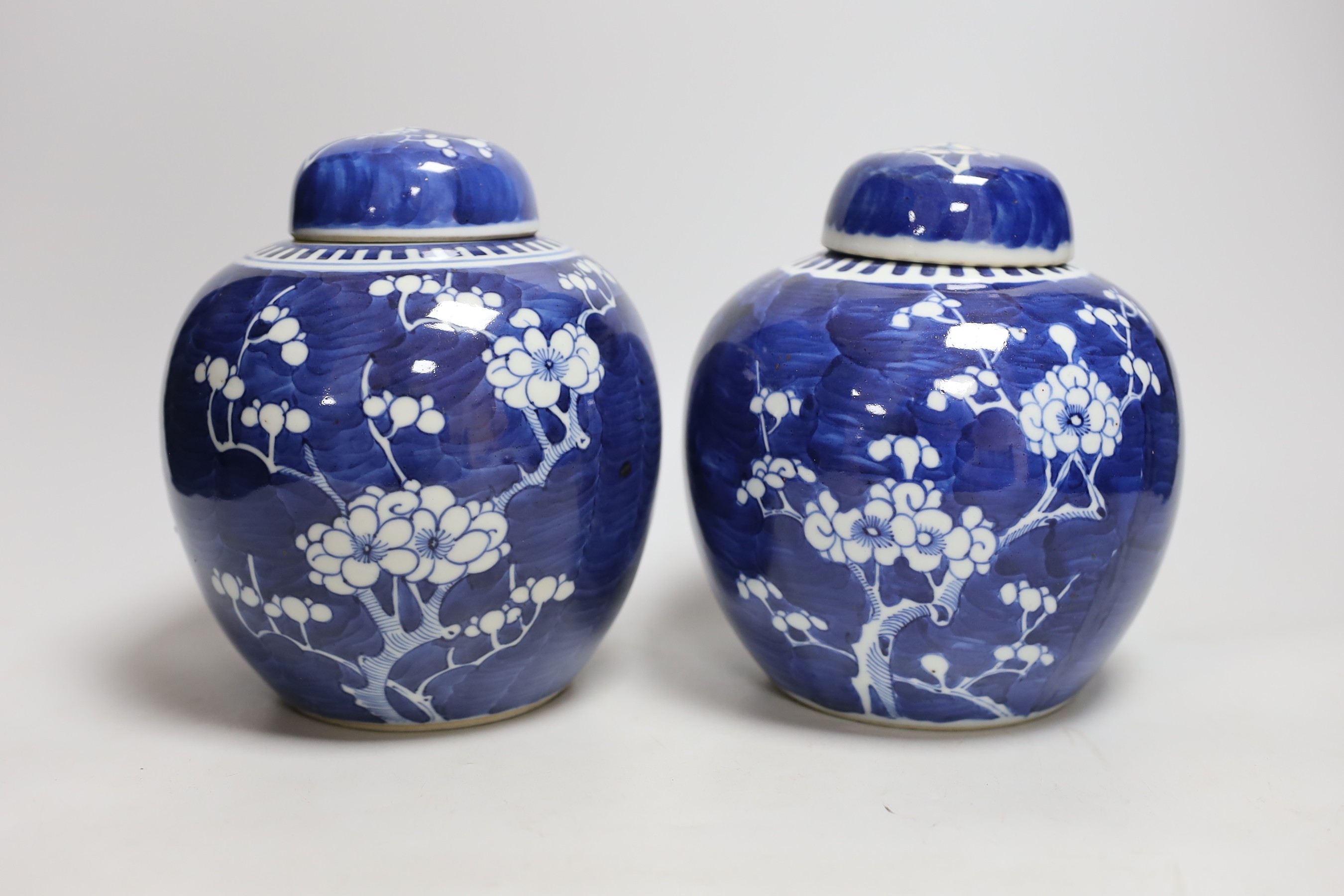 Two Chinese export porcelain Prunus blossom jars and covers, 20cms high
